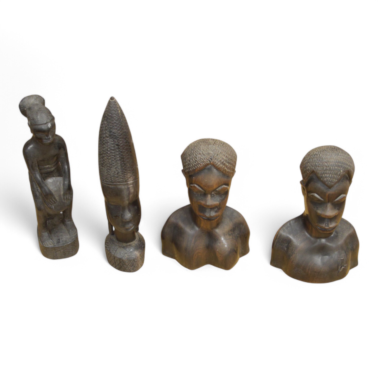 Four African wood carvings to include a figure and a pair and another bust, tallest 27cm. Condition - fair to good